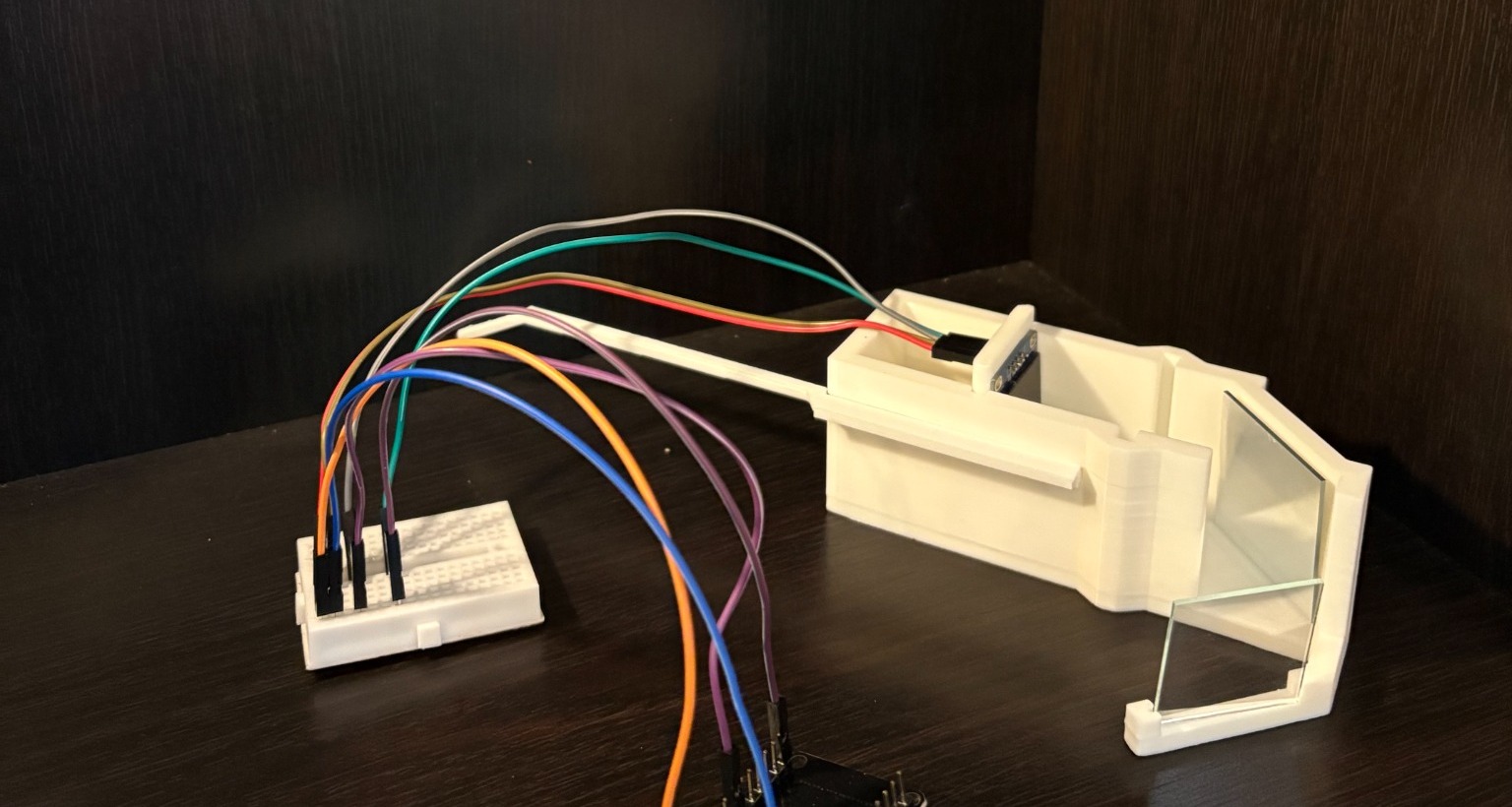 Original open smart glasses prototype with breadboard, wiring, mirror, and combiner